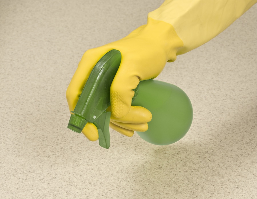 cleaning worker applying disinfectant